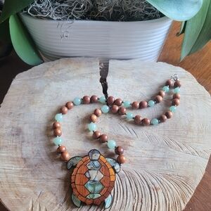 LEE SANDS Mother of Pearl Turtle Pendant Necklace with Jade and Wooden Beads.